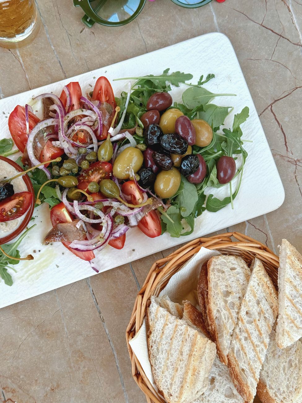 Rustic Mediterranean table spread with olives and bread